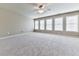 A spacious bedroom offering plush carpet flooring and multiple windows for tons of natural light at 310 River Birch Ct, Canton, GA 30114