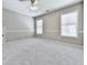 Bedroom featuring soft carpeting, two windows, chair rail, and a ceiling fan at 310 River Birch Ct, Canton, GA 30114