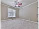 Neutral bedroom featuring large window, carpeted floors, crown molding and ceiling fan at 310 River Birch Ct, Canton, GA 30114