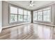 Sunny bedroom with large windows providing abundant natural light and hardwood floors at 310 River Birch Ct, Canton, GA 30114