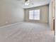 Bedroom featuring soft carpet, a ceiling fan, and a window providing natural light at 310 River Birch Ct, Canton, GA 30114