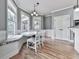 Cozy breakfast nook with large windows, built-in bench seating, and hardwood floors at 310 River Birch Ct, Canton, GA 30114