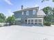 Rear view of the home featuring a spacious two-car garage, well-maintained yard, and neutral siding with white trim at 310 River Birch Ct, Canton, GA 30114
