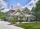 Side view of a house boasting manicured lawn, stone details, professional landscaping, and a spacious driveway at 310 River Birch Ct, Canton, GA 30114