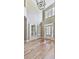 Elegant two-story foyer featuring hardwood floors, a stylish chandelier, and double doors at 310 River Birch Ct, Canton, GA 30114