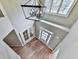Open foyer with a modern chandelier, hardwood floors and a pair of glass panel doors to the side at 310 River Birch Ct, Canton, GA 30114