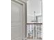 View of upstairs hallway featuring dark wood and wrought iron railing overlooking entry foyer with modern light fixture at 310 River Birch Ct, Canton, GA 30114