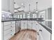 Open kitchen with hardwood floors, stainless steel dishwasher, and white cabinets at 310 River Birch Ct, Canton, GA 30114