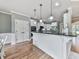 Eat-in kitchen featuring white cabinetry, modern appliances, granite countertops, and hardwood flooring at 310 River Birch Ct, Canton, GA 30114