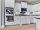 Bright kitchen featuring stainless steel appliances, tiled backsplash, and ample storage space at 310 River Birch Ct, Canton, GA 30114