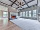 Bright living room featuring a coffered ceiling, stone fireplace, and ample windows with views at 310 River Birch Ct, Canton, GA 30114