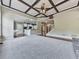 Open-concept living room with coffered ceiling flowing into the kitchen and access to the staircase at 310 River Birch Ct, Canton, GA 30114