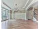 Bright living room boasts hardwood floors, wainscoting, recessed lighting, and a modern chandelier at 310 River Birch Ct, Canton, GA 30114