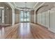 Formal living room with hardwood floors, wainscoting, large windows, and an elegant light fixture at 310 River Birch Ct, Canton, GA 30114