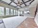 Spacious living room with coffered ceiling, plush carpet and views into the kitchen at 310 River Birch Ct, Canton, GA 30114