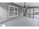 View of back porch with ceiling fan, wooden floors and walls, door and screened-in door to the deck at 310 River Birch Ct, Canton, GA 30114