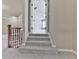 A staircase leads to a doorway providing entry to a room with carpet flooring and natural light at 310 River Birch Ct, Canton, GA 30114