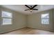 Bright bedroom with hardwood floors, natural lighting through large windows and a ceiling fan at 4131 Carroll St, Covington, GA 30014