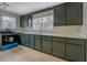 Spacious kitchen with dark green cabinets, white quartz countertops, and stainless steel appliances at 4131 Carroll St, Covington, GA 30014