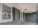 This covered porch features black window shutters and overlooks the front yard at 4131 Carroll St, Covington, GA 30014