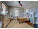 Bedroom featuring hardwood floors, light-colored walls, decorative dressers, and a large window with natural light at 5143 Floyd St, Covington, GA 30014