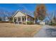 Charming single-Gathering home with a cozy front porch and well-maintained lawn on a sunny day at 5143 Floyd St, Covington, GA 30014