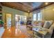 Open living room featuring unique wood ceiling, stylish furniture, and warm, neutral tones at 5143 Floyd St, Covington, GA 30014