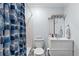 Well-lit bathroom featuring modern fixtures, a stylish mirror and tiled shower with curtain at 5400 Roswell Rd # Apt L6, Sandy Springs, GA 30342