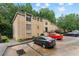 Multi-story brick apartment building featuring well-kept landscaping and ample parking for residents and guests at 5400 Roswell Rd # Apt L6, Sandy Springs, GA 30342