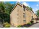 Brick apartment building with well-maintained landscaping and architectural details with a glimpse of spiral staircase at 5400 Roswell Rd # Apt L6, Sandy Springs, GA 30342