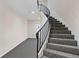 Elegant staircase featuring carpeted steps and a wrought iron railing, leading to the upper levels at 5400 Roswell Rd # Apt L6, Sandy Springs, GA 30342