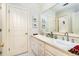 Well-lit bathroom featuring double sinks, framed mirrors, and a decorative color scheme at 5936 Millstone Ln, Stone Mountain, GA 30087