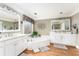 Bright bathroom features dual sinks, a soaking tub, and modern fixtures at 5936 Millstone Ln, Stone Mountain, GA 30087