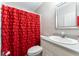 Stylish bathroom featuring a vanity, and an eye-catching red shower curtain at 5936 Millstone Ln, Stone Mountain, GA 30087