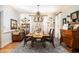 Elegant dining room with a long table, decorative chandelier, and classic furnishings at 5936 Millstone Ln, Stone Mountain, GA 30087