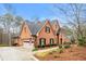 Beautiful brick home with a three-car garage, well-maintained lawn, and a welcoming facade at 5936 Millstone Ln, Stone Mountain, GA 30087