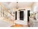 Grand foyer with hardwood floors, chandelier, and staircase with wooden banister, welcoming guests at 5936 Millstone Ln, Stone Mountain, GA 30087
