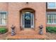 Elegant brick entrance with decorative accents and a charming front door with sidelights at 5936 Millstone Ln, Stone Mountain, GA 30087