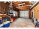 Cluttered garage featuring a variety of tools, storage containers, and exposed ceiling at 5936 Millstone Ln, Stone Mountain, GA 30087