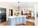 Stylish kitchen island with white countertops and blue cabinets, adjacent to a dining area at 5936 Millstone Ln, Stone Mountain, GA 30087