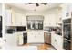 Charming kitchen with stainless steel appliances, granite countertops, and light wood cabinets at 5936 Millstone Ln, Stone Mountain, GA 30087