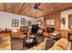 Inviting living room with a brick fireplace, comfortable seating, and wood-paneled walls and ceiling at 5936 Millstone Ln, Stone Mountain, GA 30087