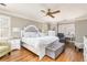 This bright and spacious main bedroom features a large bed, wood floors, and natural light at 5936 Millstone Ln, Stone Mountain, GA 30087