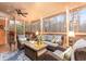 Cozy screened porch with comfortable seating and ceiling fan, overlooking a wooded area at 5936 Millstone Ln, Stone Mountain, GA 30087