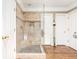 Modern tiled walk-in shower with glass door features built in seat and recessed shelves at 5936 Millstone Ln, Stone Mountain, GA 30087