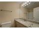 Bathroom featuring a granite countertop vanity, large mirror, and updated lighting at 170 Hidden Pines Dr, Covington, GA 30016