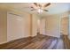 Bedroom with wood-look flooring, ceiling fan, closet, and ensuite bathroom at 170 Hidden Pines Dr, Covington, GA 30016