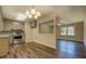 Eat-in kitchen featuring stainless steel appliances, granite countertops, and wood-look flooring at 170 Hidden Pines Dr, Covington, GA 30016