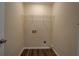 Bright laundry room with wood flooring and wire shelving for organization at 170 Hidden Pines Dr, Covington, GA 30016