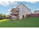 Rear of the home with a covered deck, walkout basement, and lush lawn at 1730 Dahlia Dr, Cumming, GA 30040